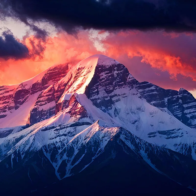 Wall Mural Mountains Majestic Snow-Capped Mountain At Sunset With Dramatic Sky